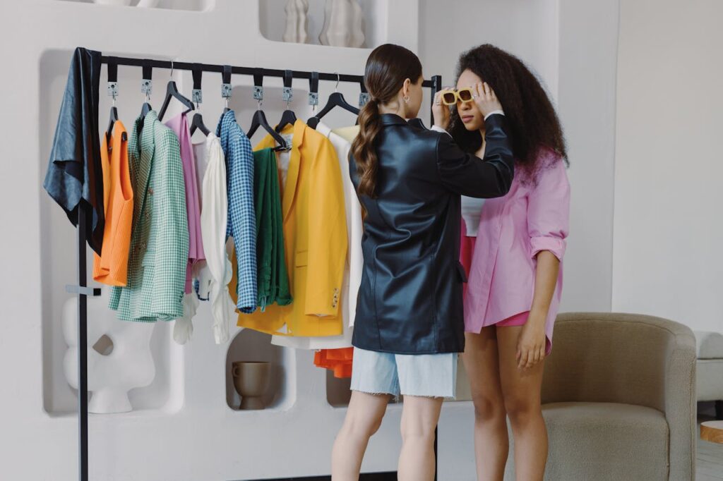 Fashion stylist assists client in a vibrant wardrobe fitting, ensuring perfect accessory choices.